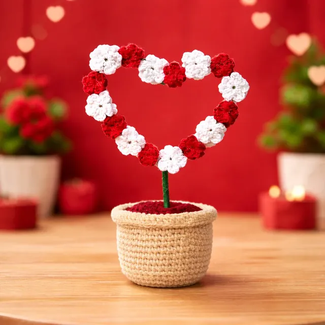 Crochet Heart Flower Pot — Red & White, on a table with red hearts, handmade by Felofey