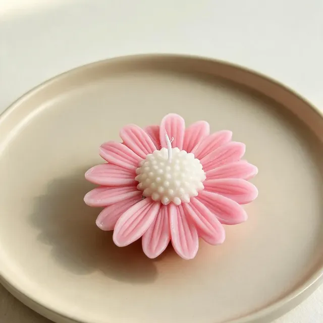 Single pink daisy floating candle, on a ceramic plate, handmade by Felofey