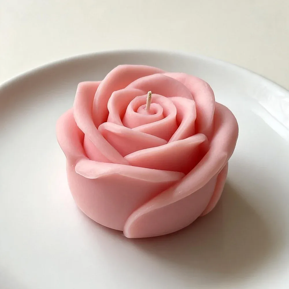 Pink rose candle on a white plate, handmade by Felofey