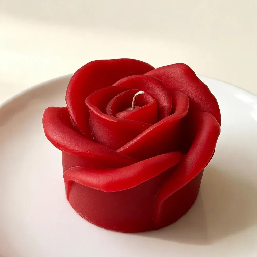 Red rose candle on a white plate, handmade by Felofey